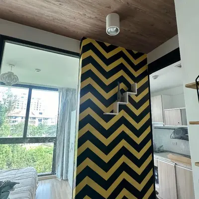 a room with a black and yellow striped wall at Connext Condominium By January in Ban Tha Khreng