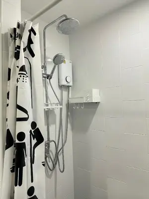 a shower with a black and white shower curtain in a bathroom at Connext Condominium By January in Ban Tha Khreng