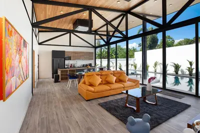 a living room with a couch and a kitchen at Brand-New 22m Oxygen Pool Villa Sunset Garden 9 in Rawai in Rawai Beach