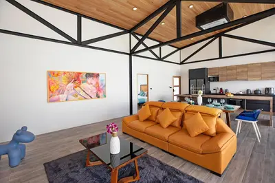 a living room with a couch and a kitchen at Brand-New 22m Oxygen Pool Villa Sunset Garden 9 in Rawai in Rawai Beach