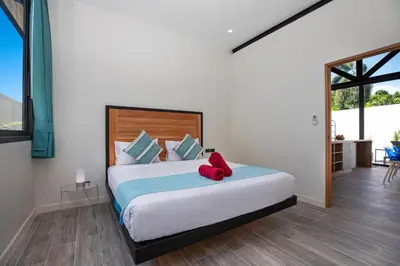 a bedroom with a large bed with red shoes on it at Brand-New 22m Oxygen Pool Villa Sunset Garden 9 in Rawai in Rawai Beach
