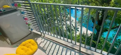 a view of a swimming pool from a balcony at Apartments pool view in Title Residence Naiyang in Nai Yang Beach