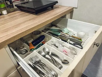 a kitchen drawer filled with dishes and utensils at Apartments pool view in Title Residence Naiyang in Nai Yang Beach