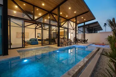 an indoor pool in a house with glass walls at New, Modern & Stylish 17m Eco Pool Villa Sunset Garden 11 in Rawai in Rawai Beach