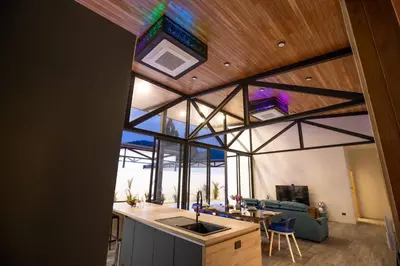 an open kitchen and living room in a house at New, Modern & Stylish 17m Eco Pool Villa Sunset Garden 11 in Rawai in Rawai Beach