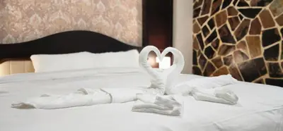 a bed with swans made out of towels on it at Arya Suites Patong Beach in Patong Beach