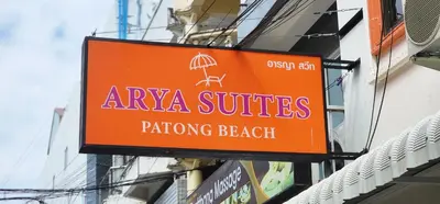 an orange sign on the side of a building at Arya Suites Patong Beach in Patong Beach