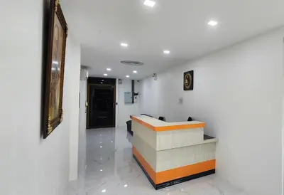 a lobby with a reception desk in a building at Arya Suites Patong Beach in Patong Beach