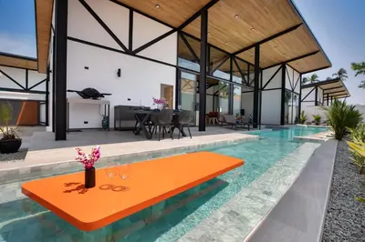 an orange table in the middle of a swimming pool in a house at Trendy & New 19m Oxygen Pool Villa Sunset Garden 10 in Rawai in Rawai Beach
