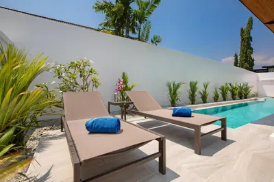 a patio with two chairs and a swimming pool at Trendy & New 19m Oxygen Pool Villa Sunset Garden 10 in Rawai in Rawai Beach