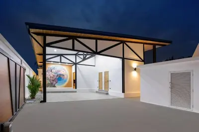an open garage with a painting on the wall at Trendy & New 19m Oxygen Pool Villa Sunset Garden 10 in Rawai in Rawai Beach