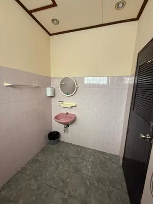 a bathroom with a pink sink and a mirror at Chaba House Koh Yao Noi in Ban Laem Sai