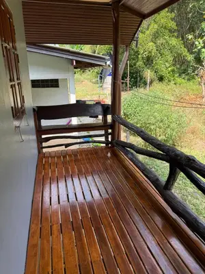 a wooden porch with a bench on a house at Chaba House Koh Yao Noi in Ban Laem Sai