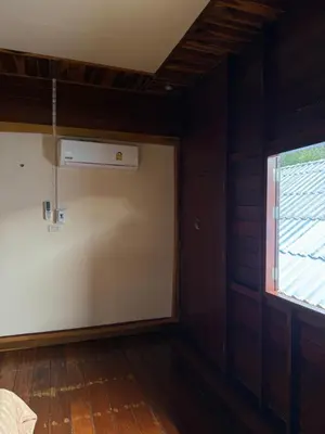 an empty room with a window and a air conditioner at Chaba House Koh Yao Noi in Ban Laem Sai