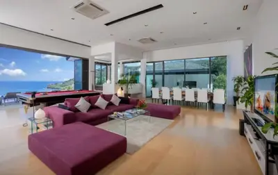 a living room with purple couches and a pool table at 15 - Ocean View Oasis in Kalim Beach in Patong Beach