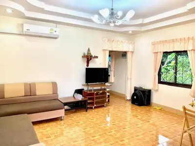 a living room with a couch and a tv at Bangtao15 Private House in Surin Beach