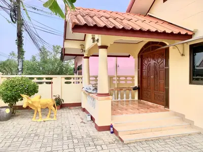 a house with a statue of a deer in front of it at Bangtao15 Private House in Surin Beach