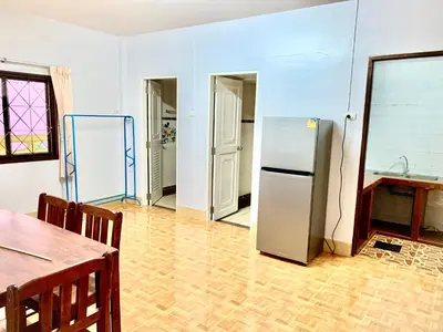 a kitchen with a refrigerator in the middle of a room at Bangtao15 Private House in Surin Beach