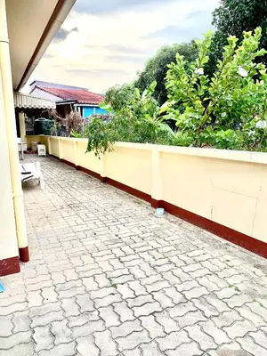 a stone walkway next to a wall with plants at Bangtao15 Private House in Surin Beach