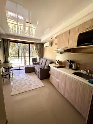 a living room with a couch and a kitchen at NBC апартаменты у пляжа in Rawai Beach