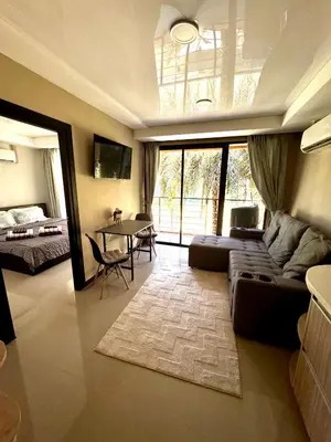 a living room with a couch and a table at NBC апартаменты у пляжа in Rawai Beach