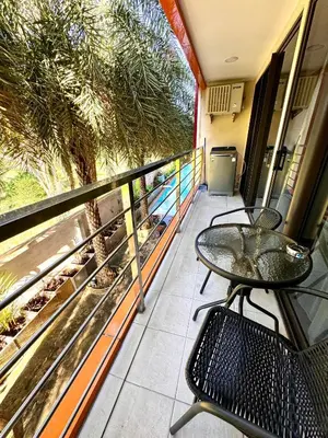 a balcony with a table and chairs on a balcony at NBC апартаменты у пляжа in Rawai Beach