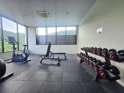 a gym with lots of exercise equipment in a room at Karon Utopia in Karon Beach