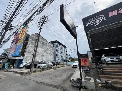 an empty street with cars parked in a parking lot at Terminal2 Hotel Phukettown in Phuket Town