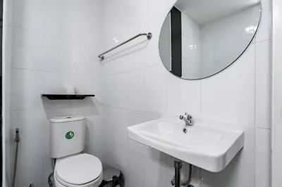 a bathroom with a toilet and a sink and a mirror at Terminal2 Hotel Phukettown in Phuket Town