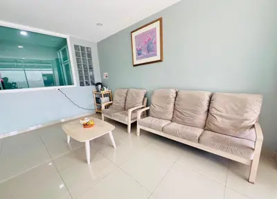 a living room with a couch and a table at Terminal2 Hotel Phukettown in Phuket Town