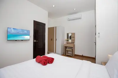 a bedroom with a white bed with a red towel on it at Newly Built 3BR Pool Villa Goldena 12B in Kamala in Kamala Beach