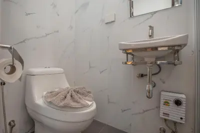a bathroom with a toilet and a sink at Newly Built 3BR Pool Villa Goldena 12B in Kamala in Kamala Beach