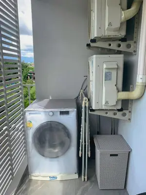 a washing machine in a small room with a utility at Cozy Paradise By Rawai Beach in Phuket Town