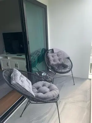a living room with two chairs and a mirror at Cozy Paradise By Rawai Beach in Phuket Town
