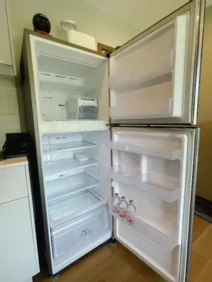 an empty refrigerator with its door open in a kitchen at Cozy Paradise By Rawai Beach in Phuket Town