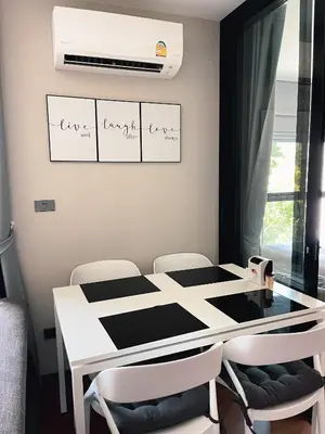 a dining room with a white table and chairs at Cozy Paradise By Rawai Beach in Phuket Town