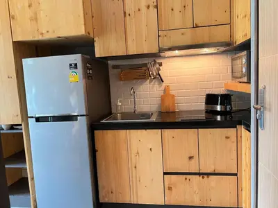 a kitchen with a white refrigerator and a sink at ReLife The Windy Naiharn in Rawai Beach