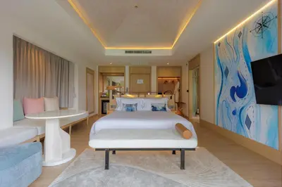 a bedroom with a bed and a tv and a couch at Centara Villas Phi Phi Island in Phi Phi Don