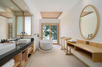 a bathroom with two sinks and a large mirror at Centara Villas Phi Phi Island in Phi Phi Don