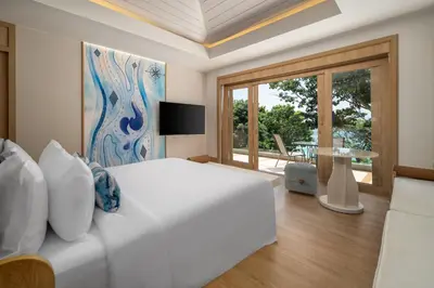 a bedroom with a white bed and a large window at Centara Villas Phi Phi Island in Phi Phi Don