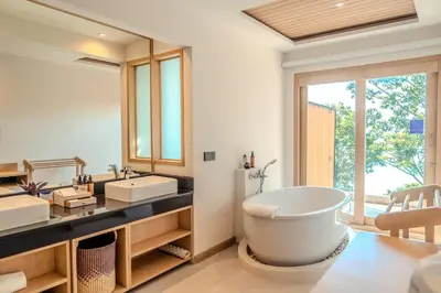 a bathroom with a large tub and two sinks at Centara Villas Phi Phi Island in Phi Phi Don