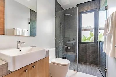 a bathroom with a sink and a shower at Botanica Modern Loft by Villacarte in Ban Pak Lak