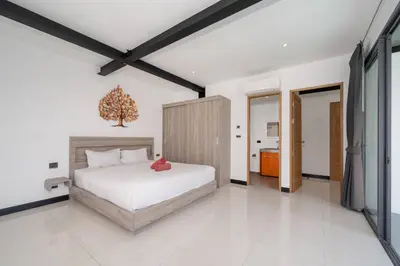 a bedroom with a large white bed in a room at New & Modern, Loft Style 4BR Villa Sunset Garden 3, 12m Salt Pool, just 10min drive Naiharn Beach in Rawai Beach