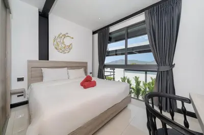 a bedroom with a bed with a red stuffed animal on it at New & Modern, Loft Style 4BR Villa Sunset Garden 3, 12m Salt Pool, just 10min drive Naiharn Beach in Rawai Beach