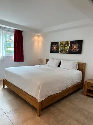 a bedroom with a large bed with white sheets at Ocean View Residences! in Phuket Town