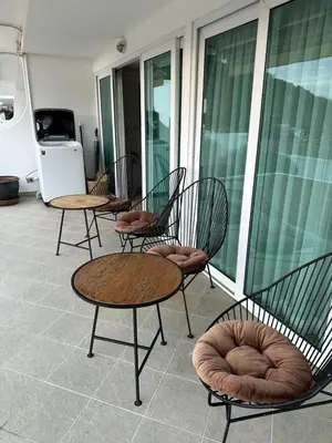a group of chairs and tables on a balcony at Ocean View Residences! in Phuket Town