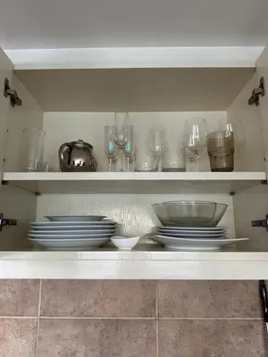a shelf with plates and bowls and glasses on it at Ocean View Residences! in Phuket Town