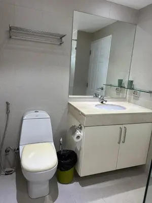 a bathroom with a toilet and a sink and a mirror at Ocean View Residences! in Phuket Town