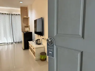a room with a door with a sign on it at Five Loaves Beds Patong in Patong Beach