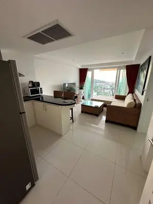 a kitchen and living room with a couch and a table at Ocean View Residences! in Karon Beach